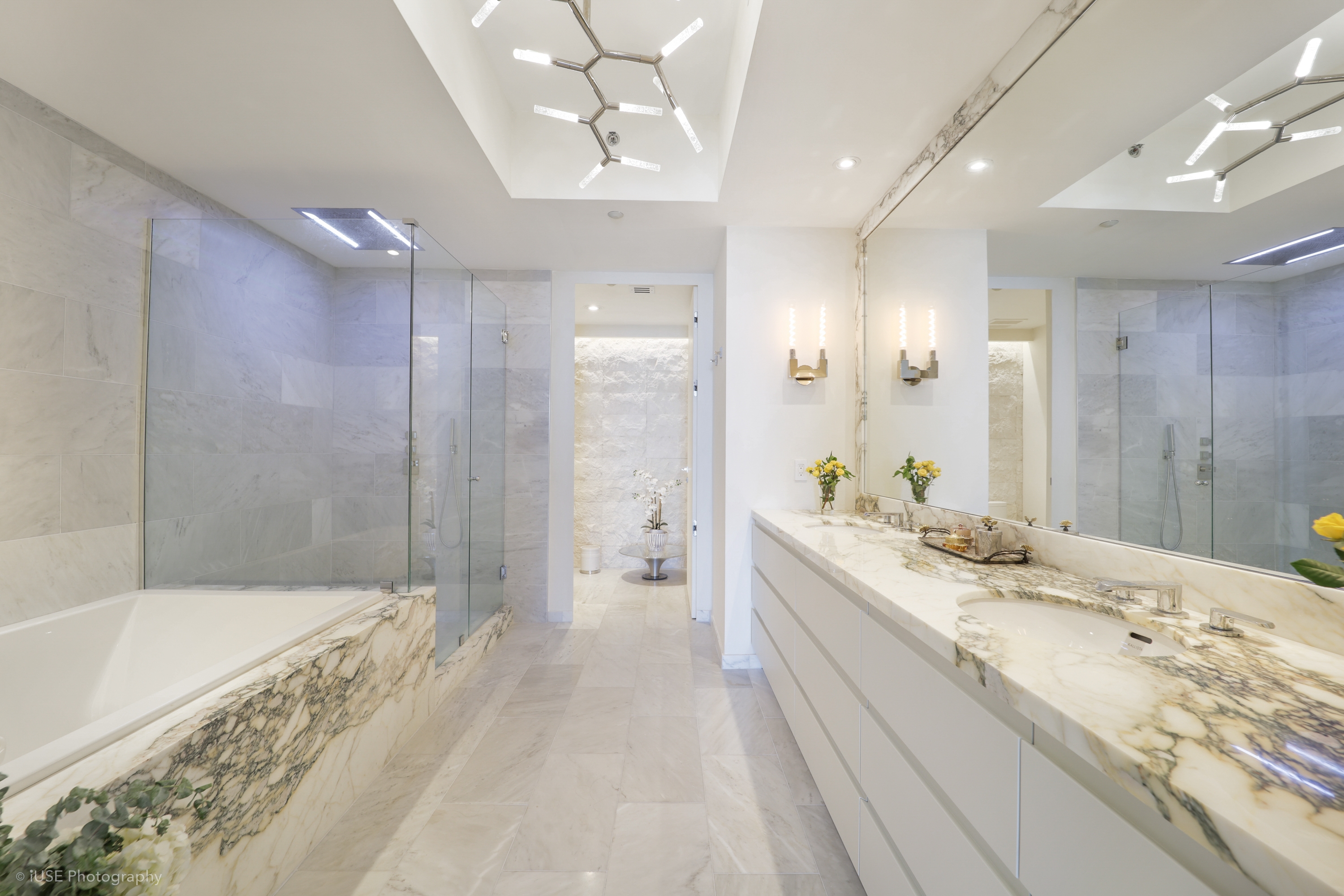 Master bathroom with Calacatta marble tub surround and hexagonal light fixture